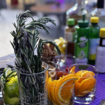display of bar garnishes - rosemary, limes, and more