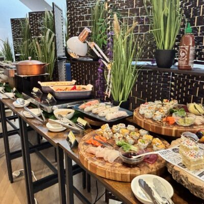 Buffet of sushi, summer rolls and desserts
