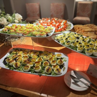 display of three different flavors of deviled eggs - candied bacon, bloody mary and vegetarian caviar