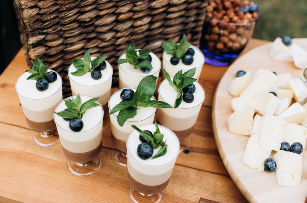 display of mocha mousse in small cups with a tray of cheese cubes
